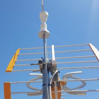 Installation of the Scarecrow for Antenna on the Roof of a House. Zoom on Mast Attachment with Cable Ties