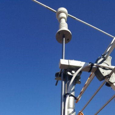 Installation of the Scarecrow for Antenna on the Roof of a House. Zoom on Mast Attachment. View from Below